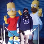 AprilCoxTravel standing between Bart & Homer Simpson