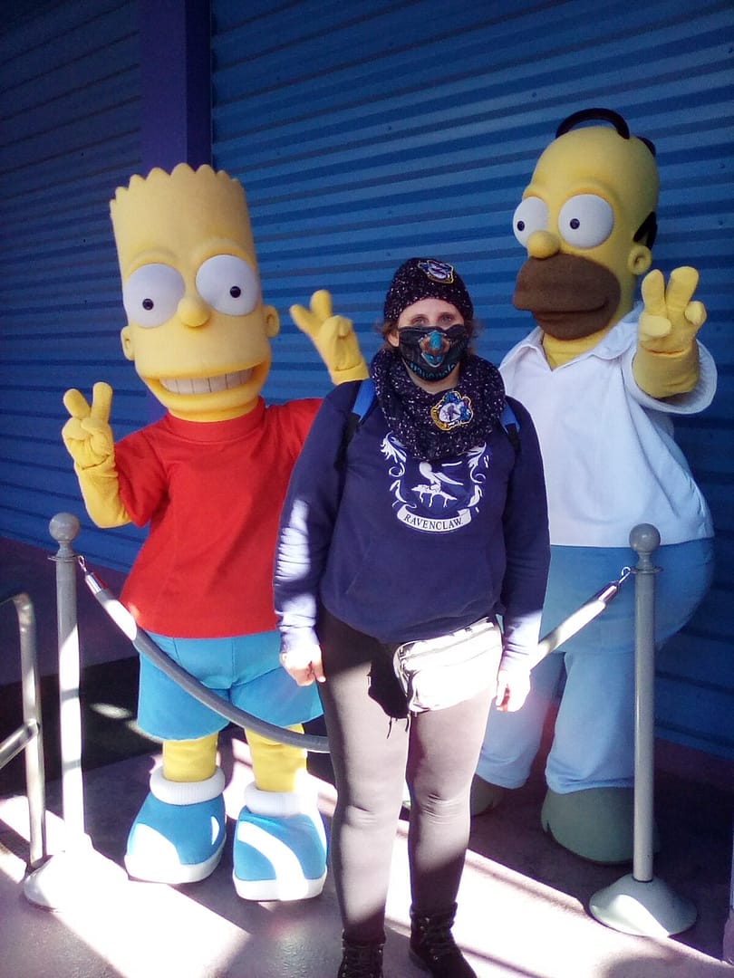 AprilCoxTravel standing between Bart & Homer Simpson